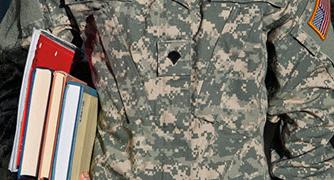 An image of a military student holding books. 