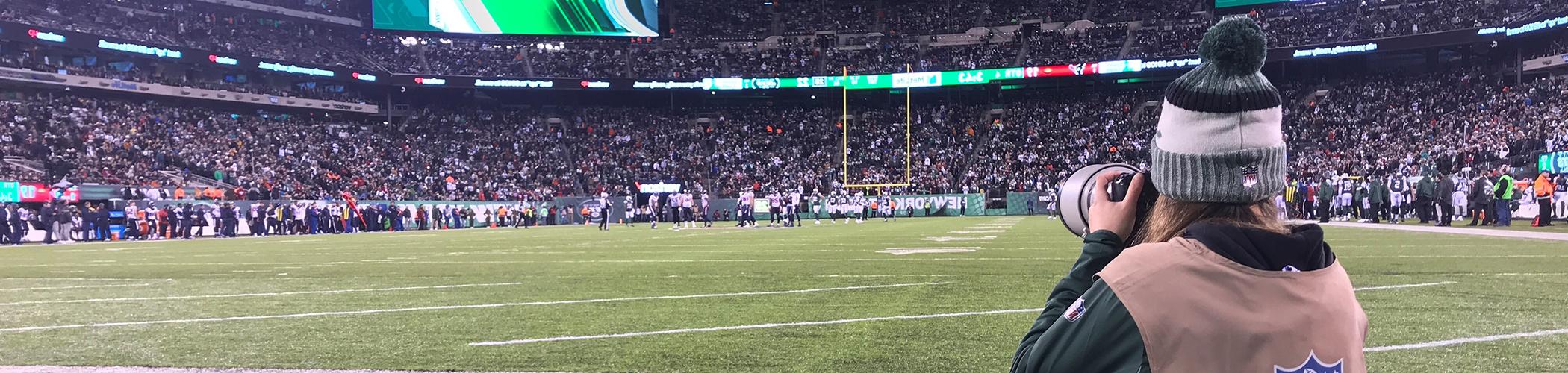 Photo of student Gabriella Ricciardi photographing Jets game