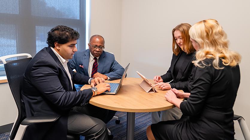 Image of students and career coaches sitting at a table in the Center for Career Servies.