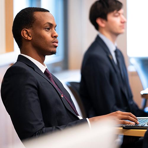 Image of Loik Makuza sitting in class.